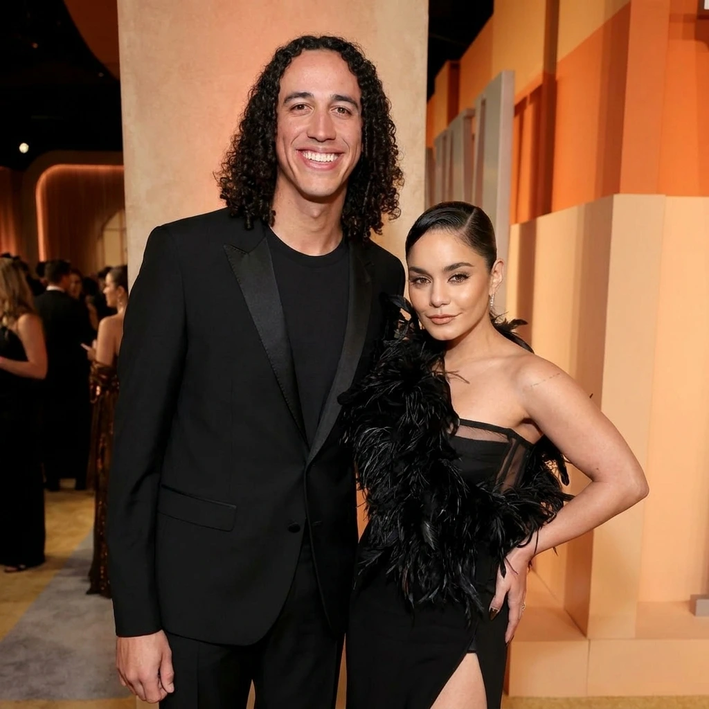 Actress Vanessa Hudgens and baseball player Cole Tucker hugging on a red carpet.