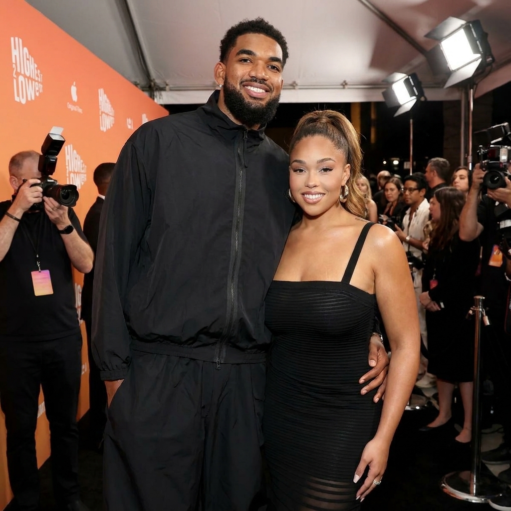 Model Jordyn Woods and NBA player Karl-Anthony Towns standing together on the red carpet.