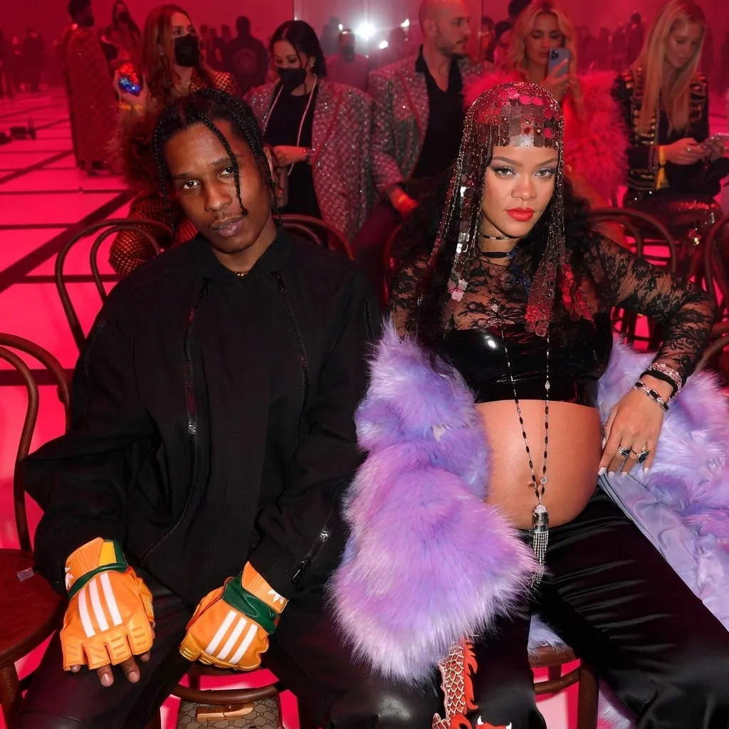 ASAP Rocky and Rihanna sitting together front row at a fashion show, highlighting ASAP Rocky on Rihanna's billionaire status
