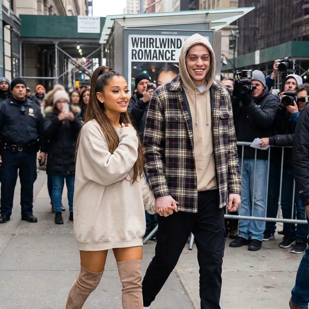 Ariana Grande and Pete Davidson holding hands while walking down a city street.