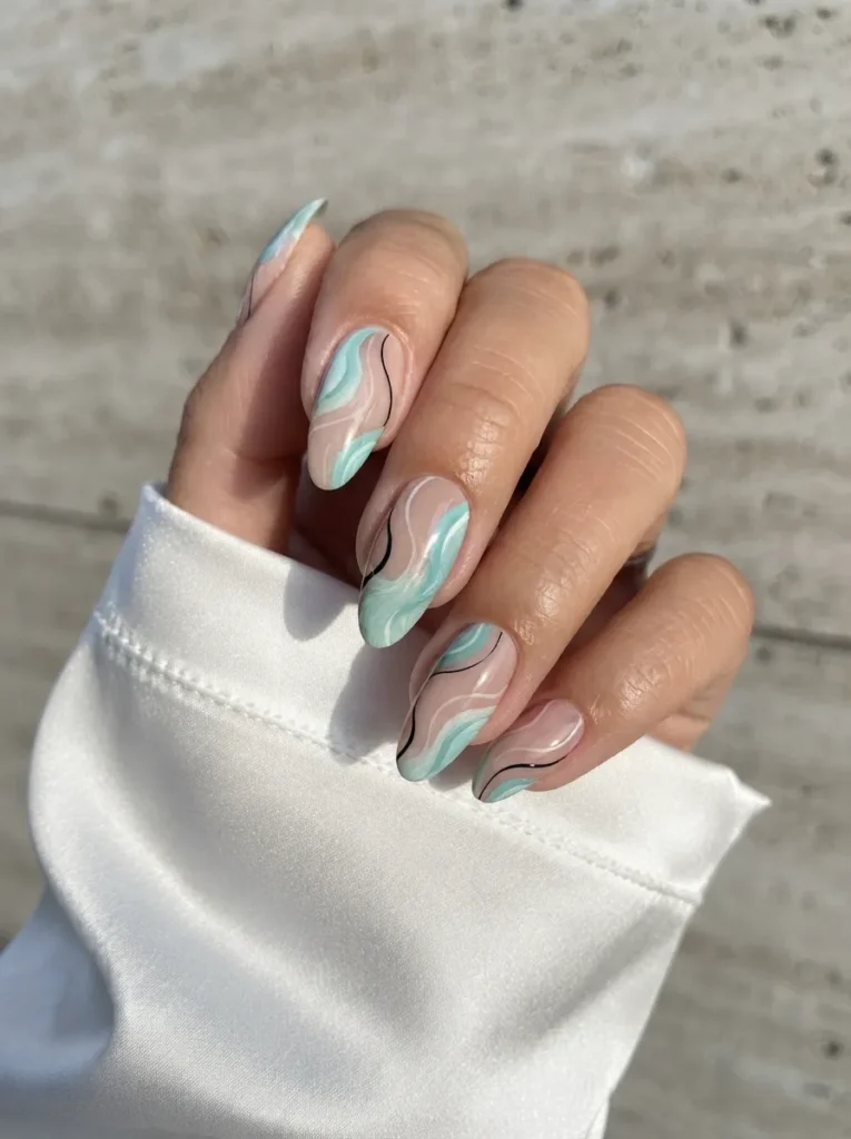 Almond-shaped nails showcasing abstract mint and black swirl line art against a neutral base.