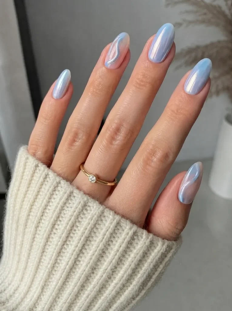 Almond-shaped nails with pearly blue chrome and swirly line accents